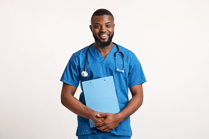 Smiling Male CNA with medical chart